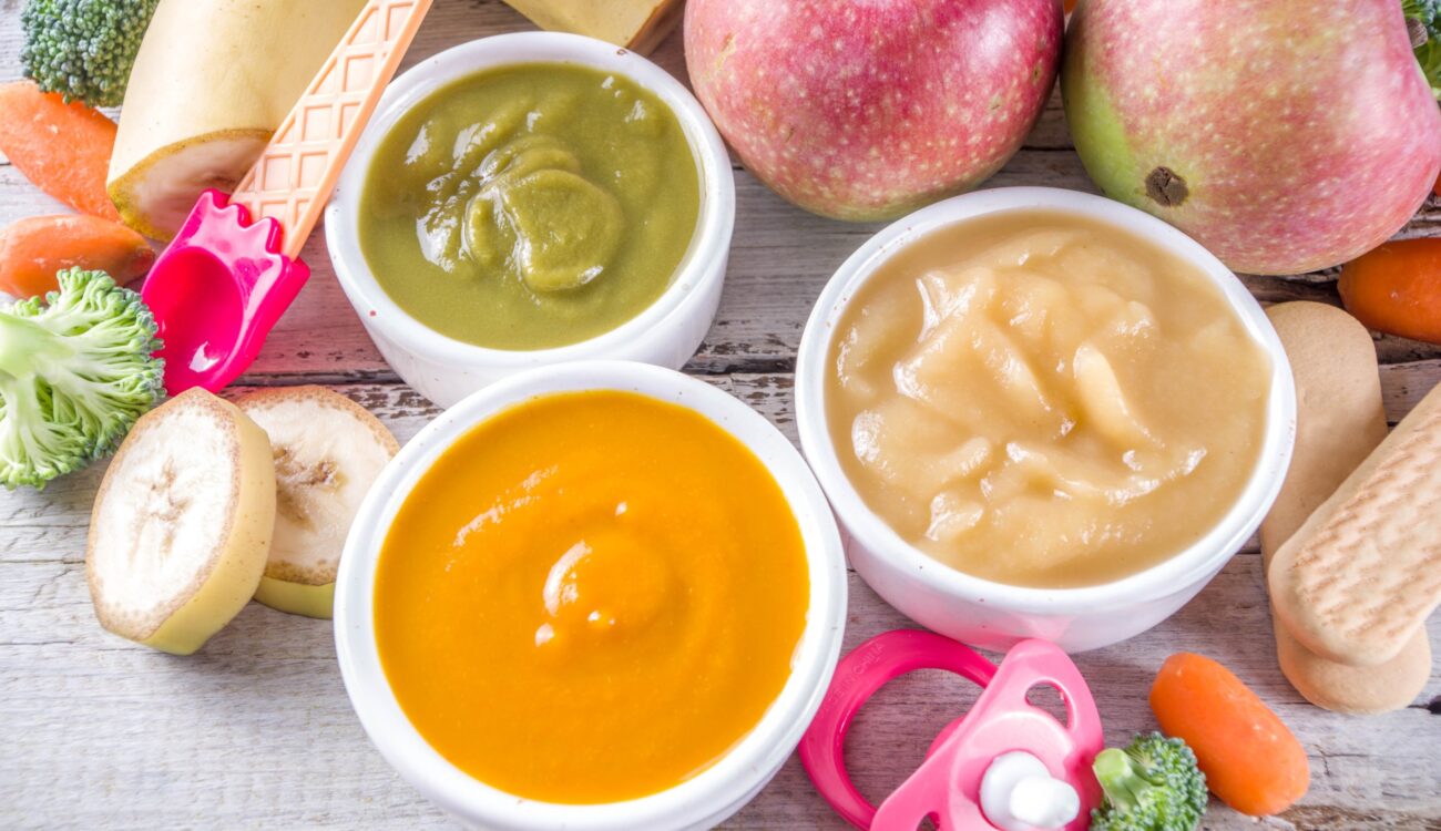 A selection of organic baby food jars, featuring colorful labels and nutritious ingredients for young children.