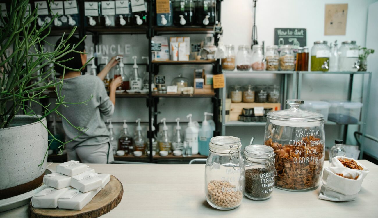 An inviting organic shop showcasing fresh produce, eco-friendly products, and natural health items on wooden shelves.